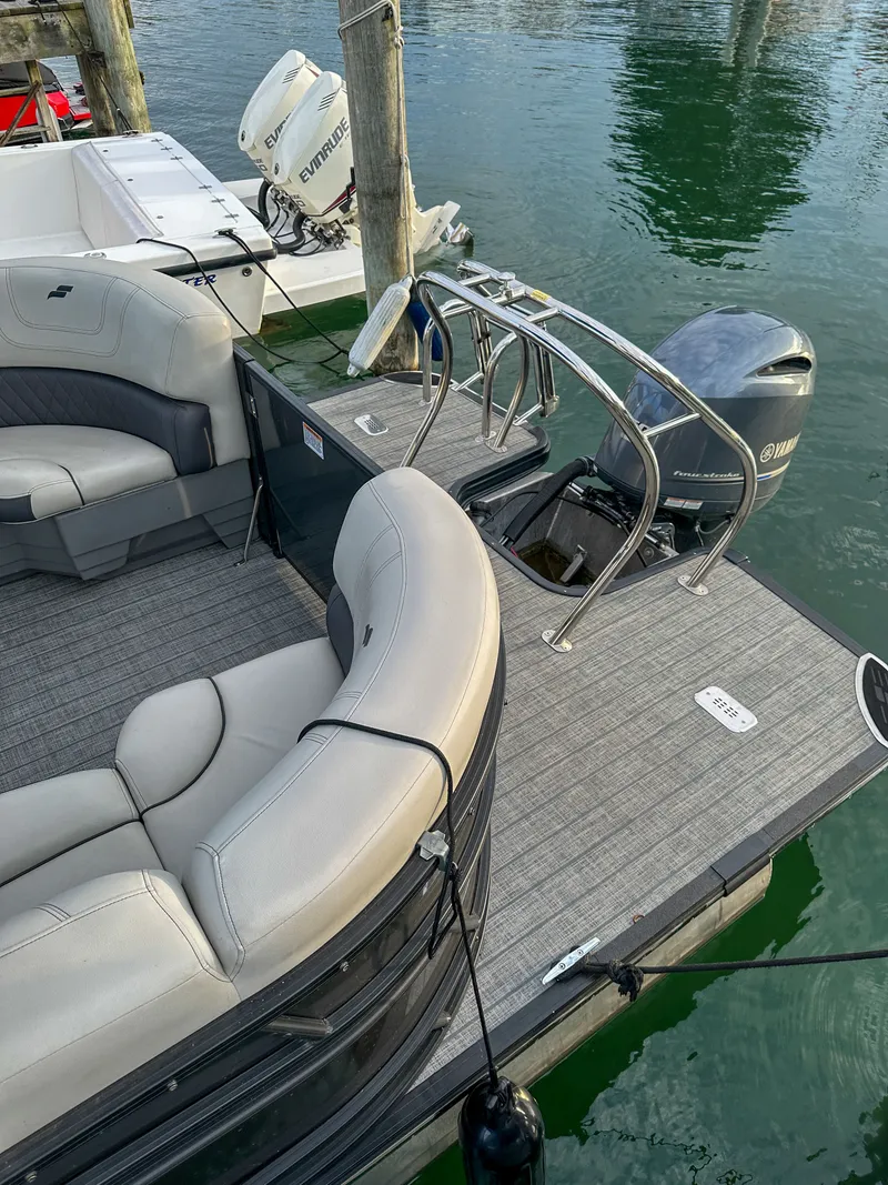 Slide: The Image of Starcraft 25 SLS 2021 pontoon boat docked with outboard motor. - 7