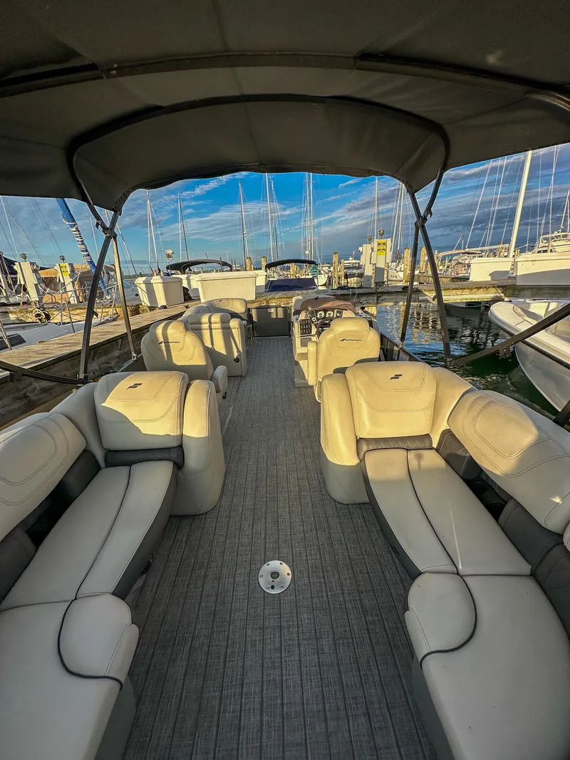 Slide: The Image of Interior view of a 2021 Starcraft 25 SLS pontoon boat at the marina. - 8