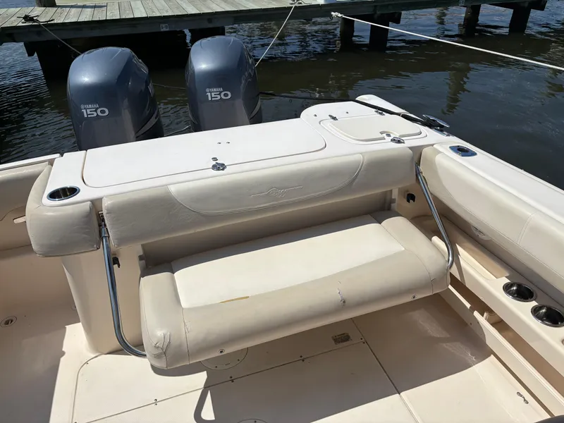 Slide: The Image of 2011 Grady-White Freedom 275 boat with Yamaha 150 engines, docked by the water. - 13