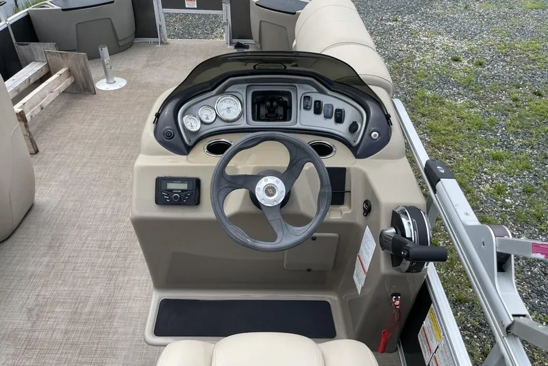 Slide: The Image of 2023 Sun Tracker Fishin' Barge 20 DLX steering console with gauges and controls. - 10