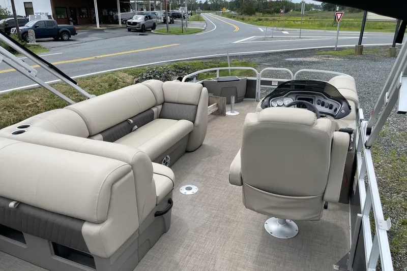 Slide: The Image of 2023 Sun Tracker Fishin' Barge 20 DLX interior with beige seating and steering console. - 6