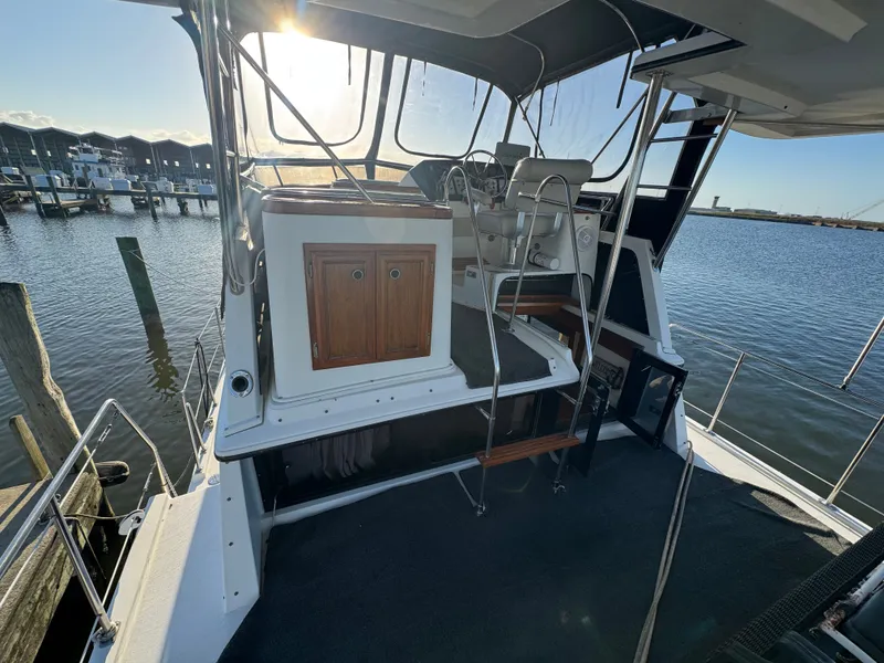 Slide: The Image of 1987 Carver 3607 Aft Cabin Yacht docked at sunset. - 27