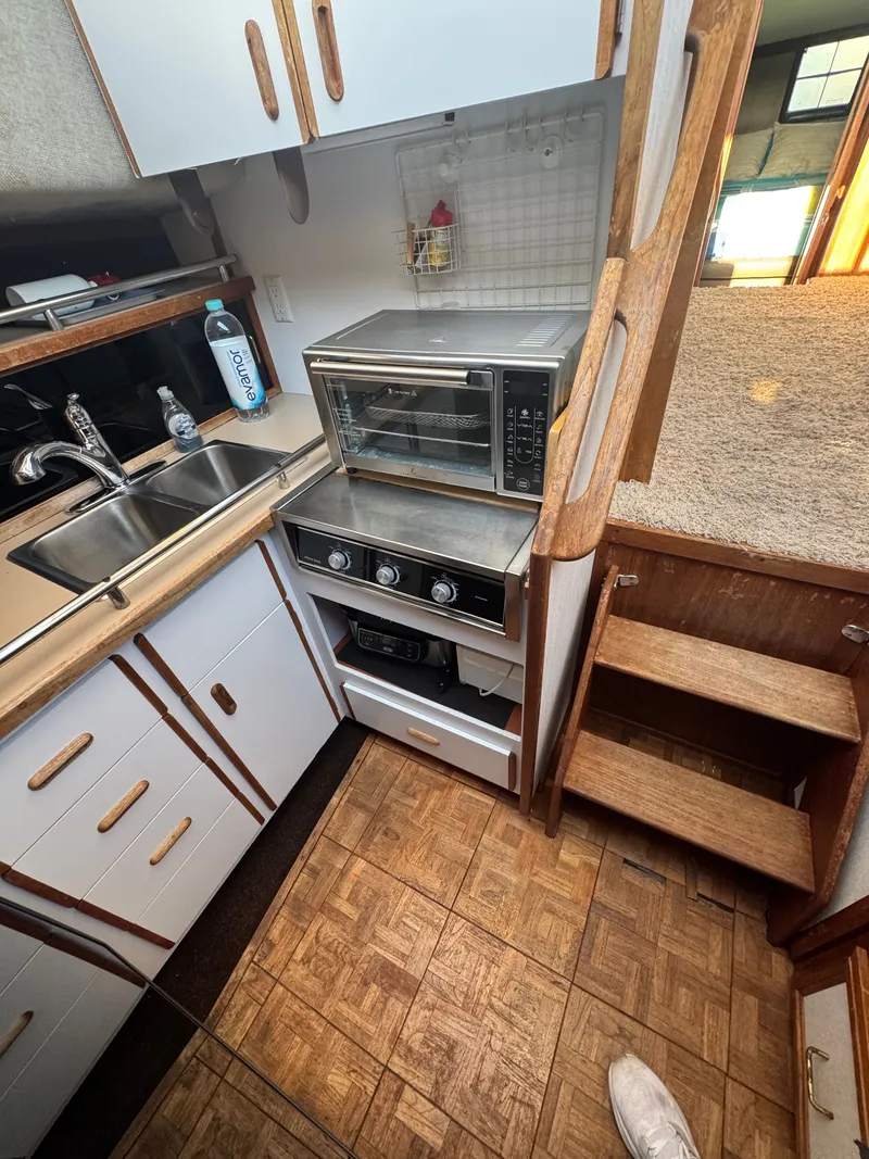 Slide: The Image of 1987 Carver 3607 yacht kitchen with stove and sink. - 12