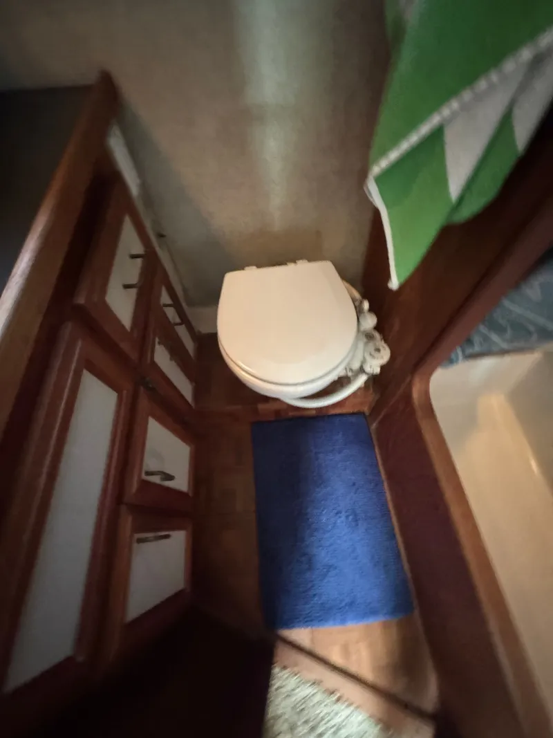 Slide: The Image of Interior of 1987 Carver 3607 Yacht with toilet and cabinets. - 22