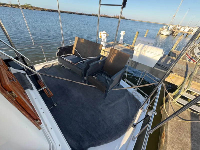 Slide: The Image of 1987 Carver 3607 Yacht with seating area by the water. - 26