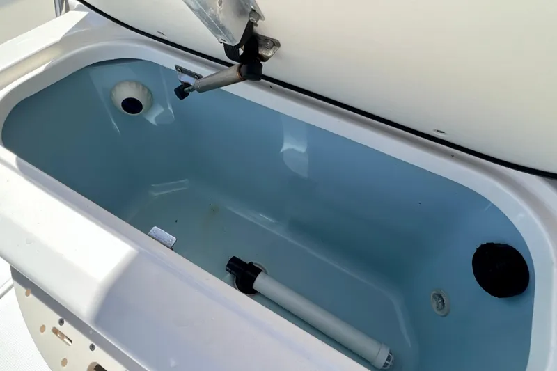 Slide: The Image of Livewell compartment in 2023 Boston Whaler 210 Montauk boat, open lid view. - 11