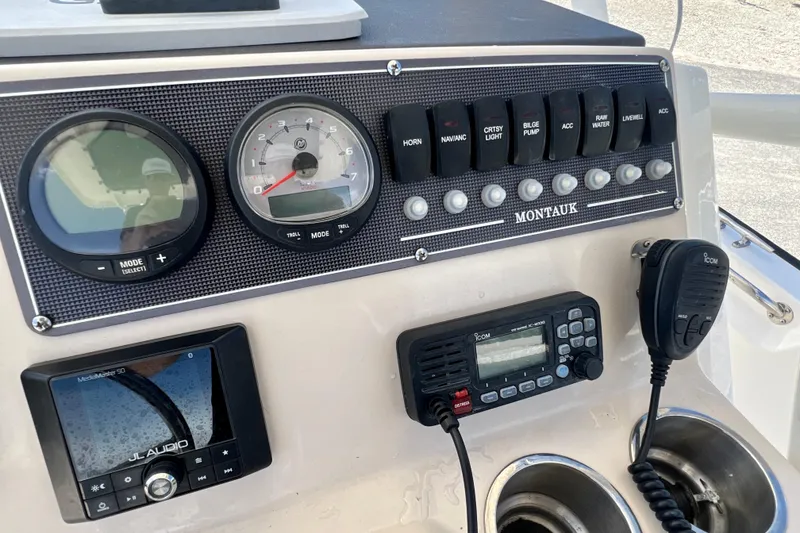 Slide: The Image of Control panel of 2023 Boston Whaler 210 Montauk with gauges and communication devices. - 12