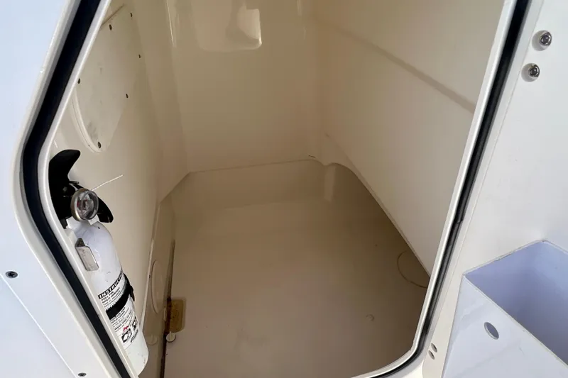 Slide: The Image of Interior storage compartment of 2023 Boston Whaler 210 Montauk with fire extinguisher. - 8