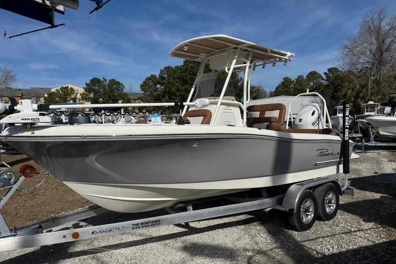 The Image of 2023 Pioneer 202 Islander boat on trailer, displayed outdoors under clear blue sky. - 0