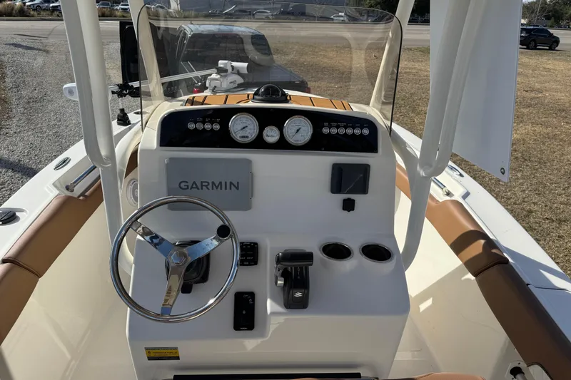 Slide: The Image of 2023 Pioneer 202 Islander boat dashboard with Garmin navigation system and steering wheel. - 5