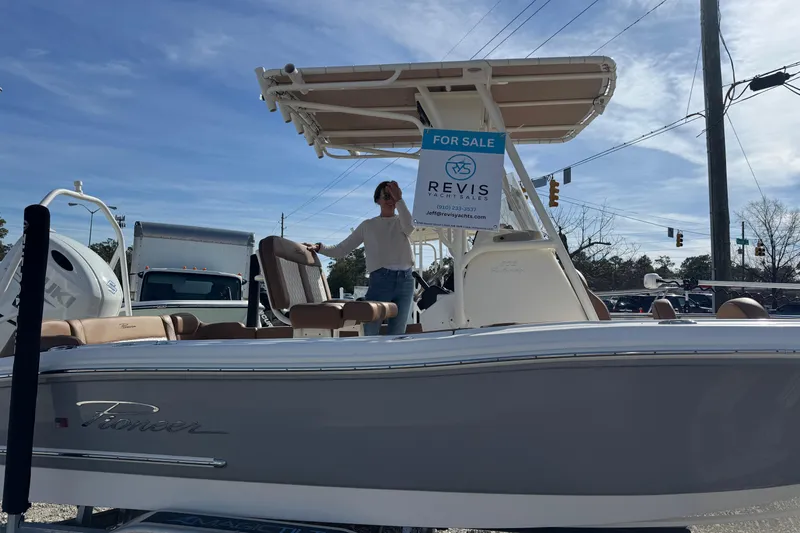 Slide: The Image of 2023 Pioneer 202 Islander boat for sale, displayed outdoors with a sales sign. - 7