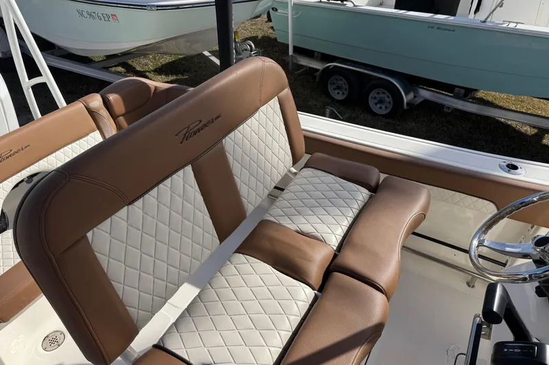 Slide: The Image of 2023 Pioneer 202 Islander boat interior with brown and white quilted seating. - 8