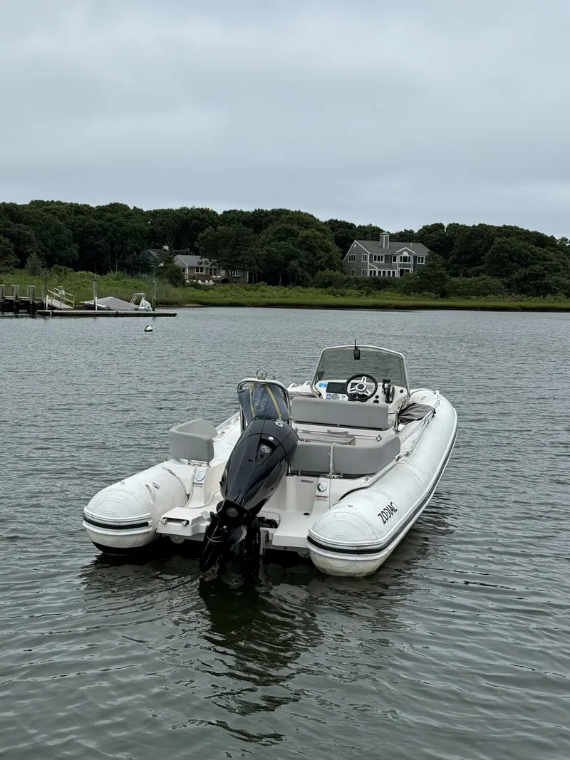 Slide: The Image of Zodiac nZO 680 boat 2022 on calm water with coastal backdrop. - 1
