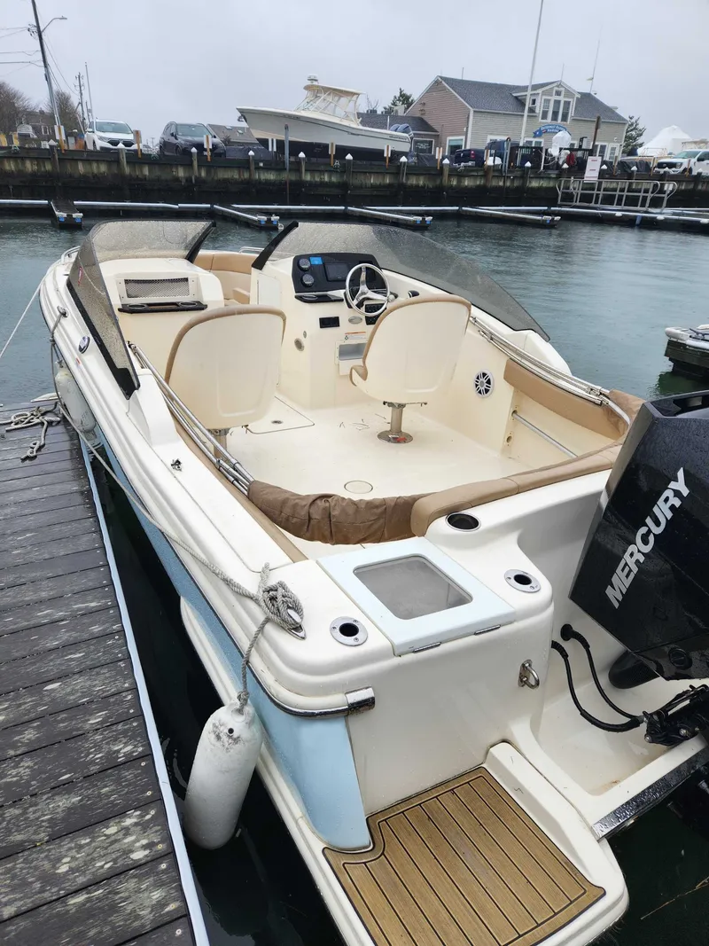 Slide: The Image of Scout 215 Dorado 2022 boat docked with Mercury engine. - 1