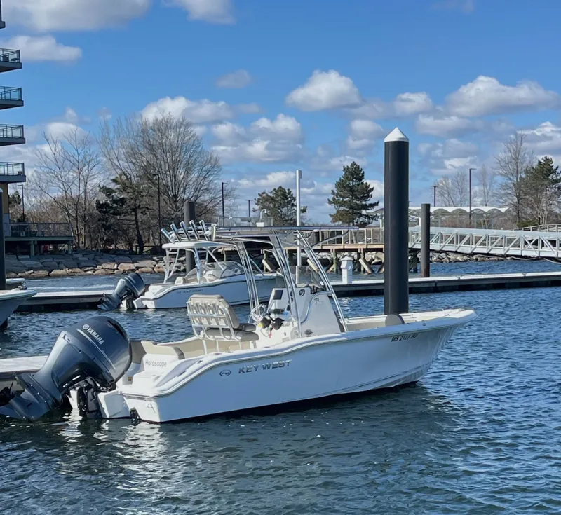 Slide: The Image of 2023 Key West 219 FS boat docked in sunny harbor. - 2