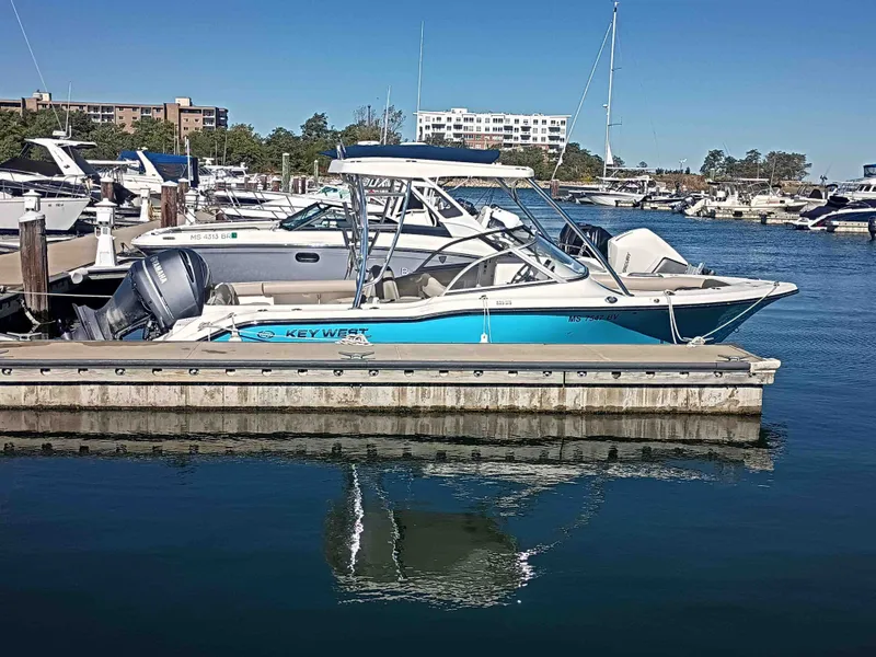 Slide: The Image of 2024 Key West 239 DFS boat docked in marina. - 2