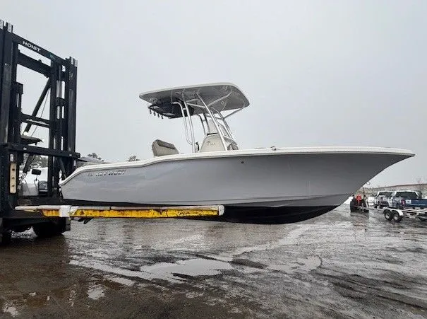 Slide: The Image of 2024 Key West 239 FS boat on forklift, gray sky. - 4