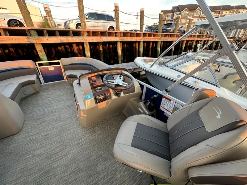 Slide: The Image of Interior of a 2023 Bennington 23SXSRC pontoon boat with luxurious seating. - 2