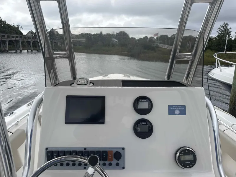 Slide: The Image of Helm console of a 2024 Key West 239 FS boat on a river. - 6
