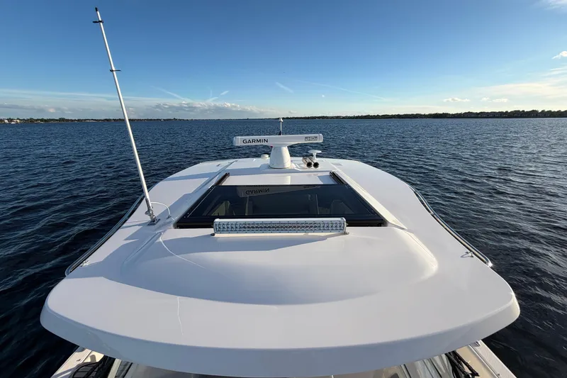 Slide: The Image of 2021 Regal 38 SAV yacht on open water, featuring Garmin radar and sleek design. - 15