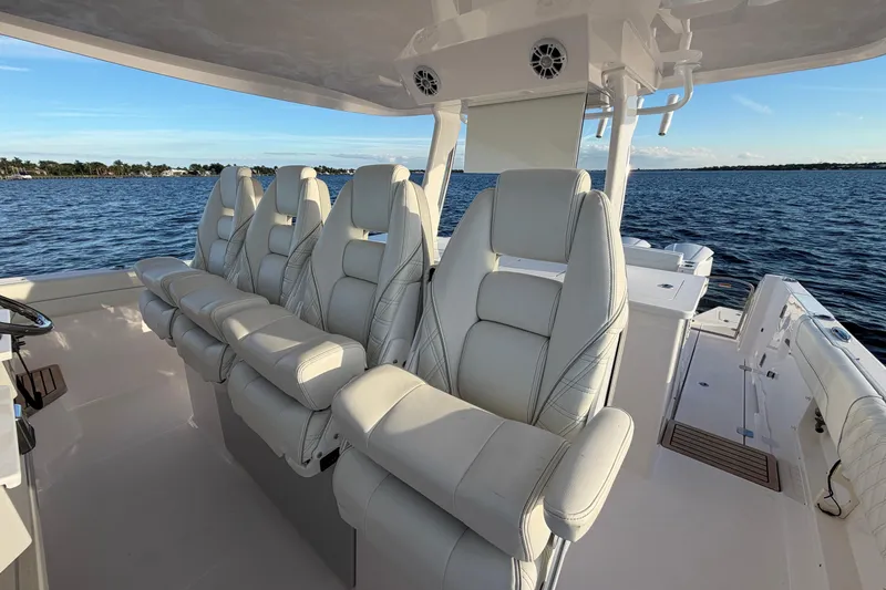 Slide: The Image of Luxurious seating on 2021 Regal 38 SAV boat, overlooking serene water. - 3
