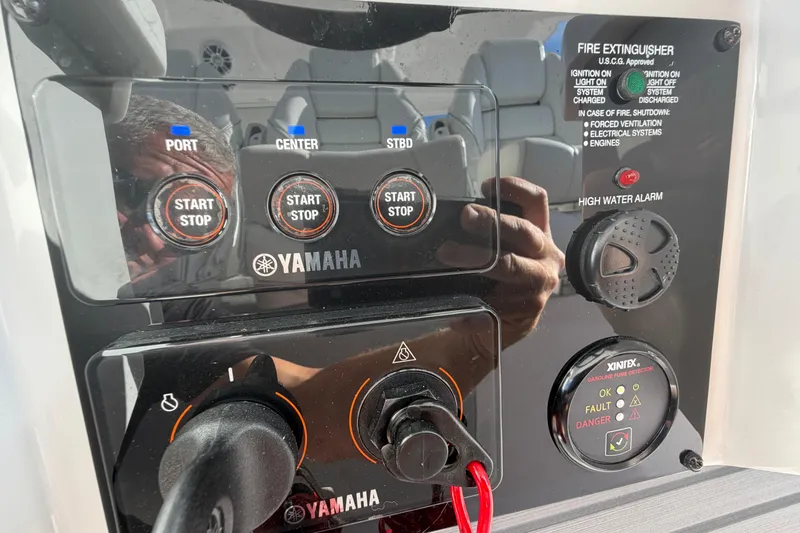 Slide: The Image of Control panel of a 2021 Regal 38 SAV boat with Yamaha start/stop buttons. - 38