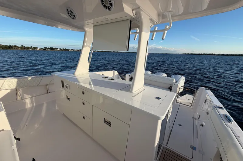 Slide: The Image of 2021 Regal 38 SAV boat interior with sleek white cabinetry and ocean view. - 6