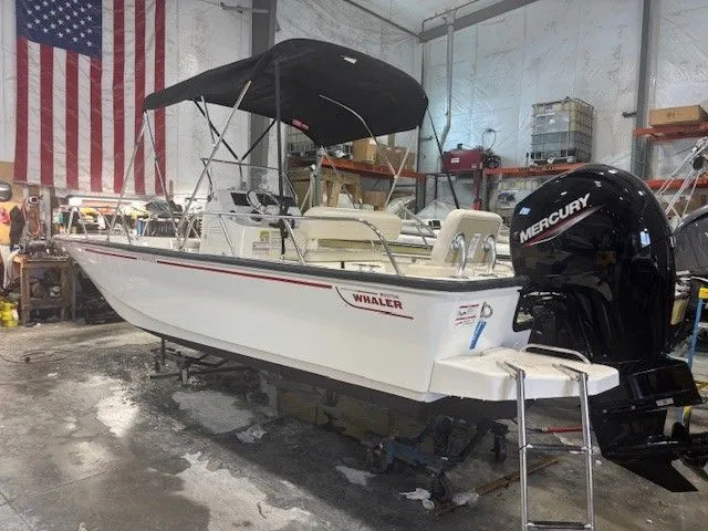 Slide: The Image of 2025 Boston Whaler 190 Montauk in a workshop with US flag. - 3