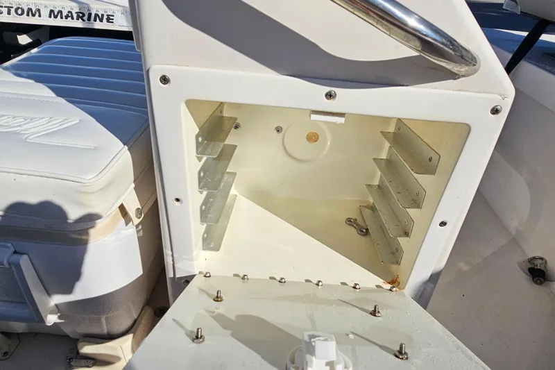 Slide: The Image of 2002 Maverick 17 HPX Mirage Tunnel boat storage compartment with open lid and seating area. - 18