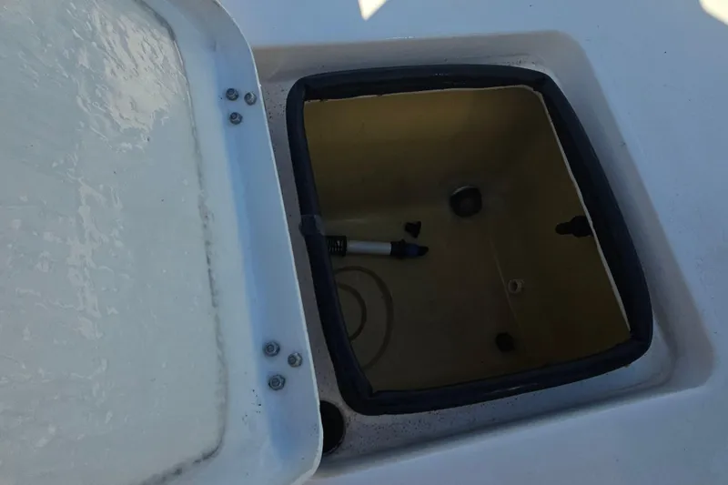 Slide: The Image of Open storage compartment on a 2002 Maverick 17 HPX Mirage Tunnel boat. - 22