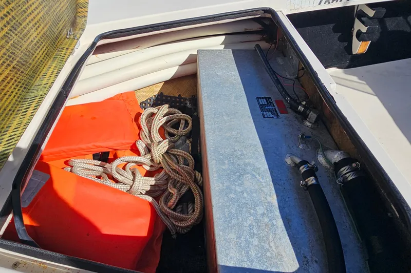 Slide: The Image of Storage compartment of 2002 Maverick 17 HPX Mirage Tunnel with life jackets and ropes. - 28