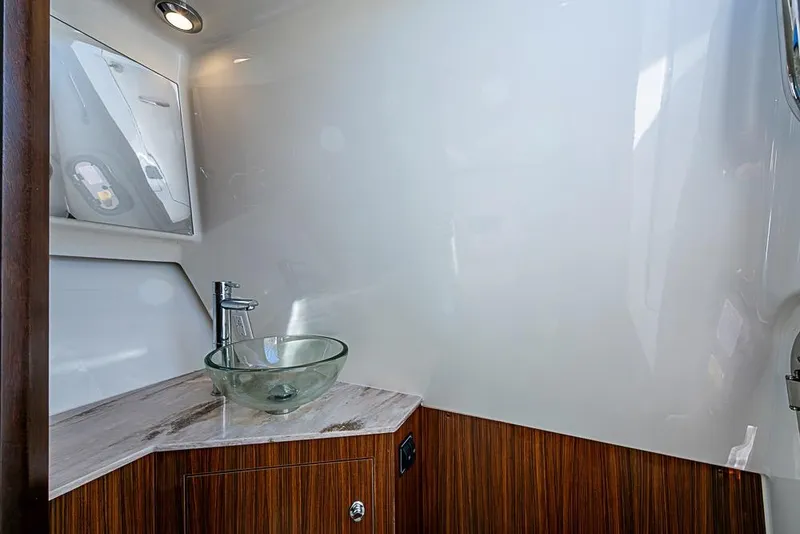Slide: The Image of 2020 Pursuit DC 365 Dual Console bathroom with modern glass sink and wooden cabinetry. - 29