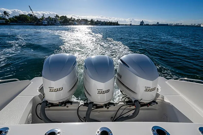 Slide: The Image of 2020 Pursuit DC 365 Dual Console with triple Yamaha 300 engines on open water. - 30