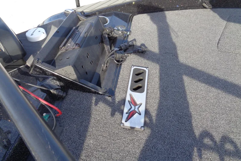 Slide: The Image of 2022 Vexus DVX22 boat deck with control panel and star emblem. - 10