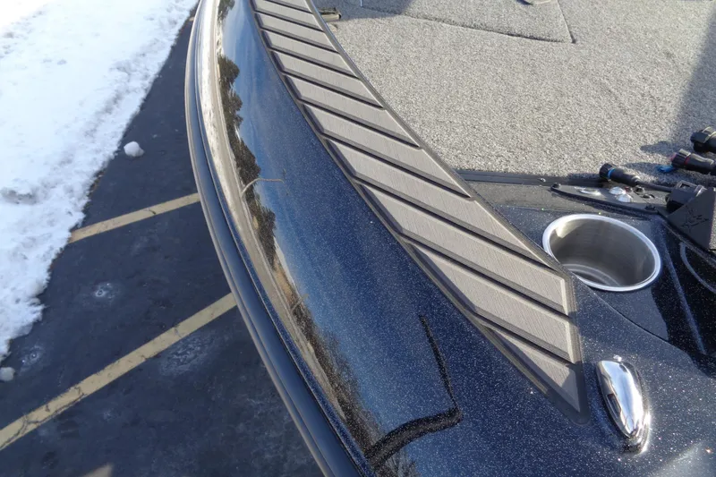 Slide: The Image of 2022 Vexus DVX22 boat deck with textured surface and cup holder, parked on snowy pavement. - 15