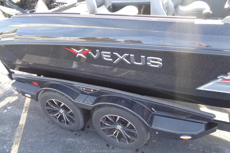 Slide: The Image of 2022 Vexus DVX22 boat on trailer, showcasing sleek design and branding. - 16