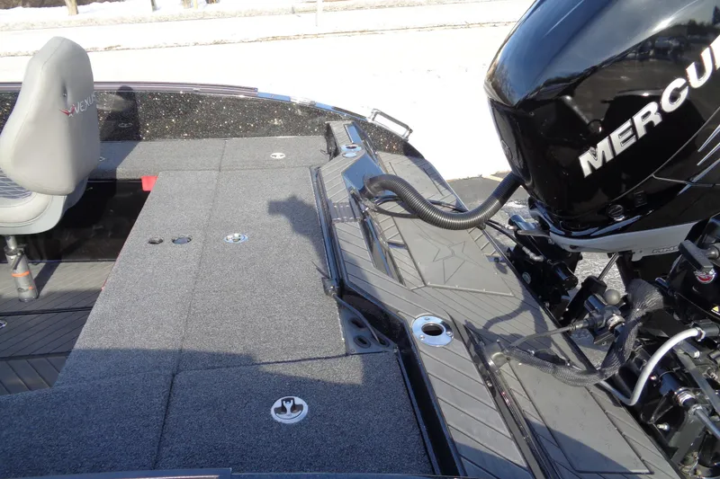 Slide: The Image of 2022 Vexus DVX22 boat interior with Mercury engine, featuring gray seating and deck. - 30