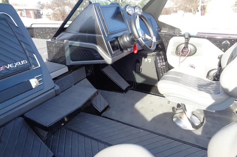 Slide: The Image of Interior of a 2022 Vexus DVX22 boat featuring modern controls and seating. - 32