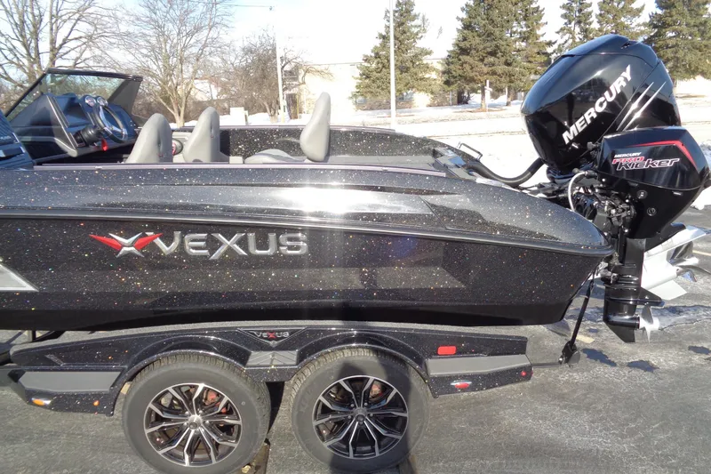 Slide: The Image of 2022 Vexus DVX22 boat with Mercury engine, parked on a trailer in a sunny outdoor setting. - 4
