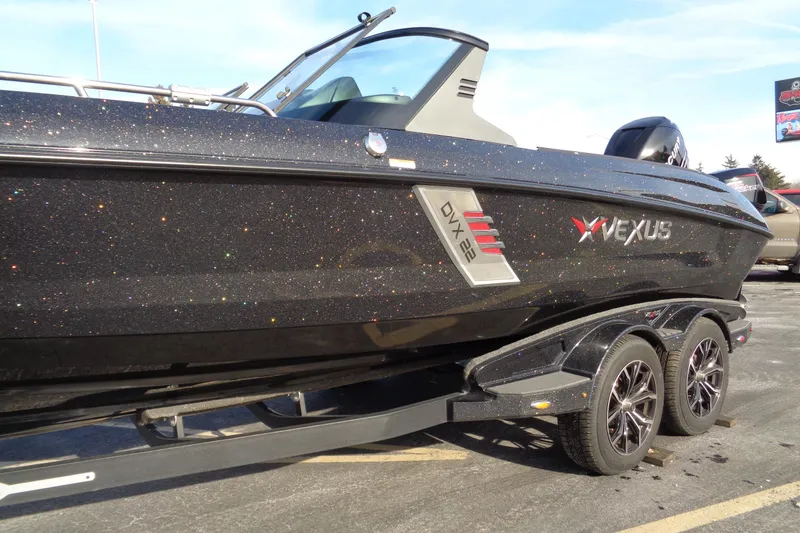 Slide: The Image of 2022 Vexus DVX22 boat with sparkling black finish on a trailer. - 7