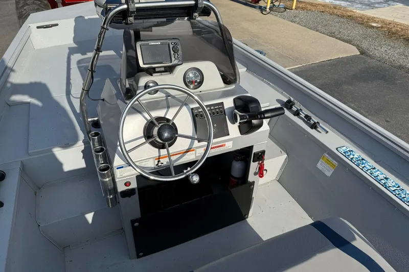 Slide: The Image of 2022 G3 Gator Tough 17 CCJ DLX boat console with steering wheel and controls. - 11