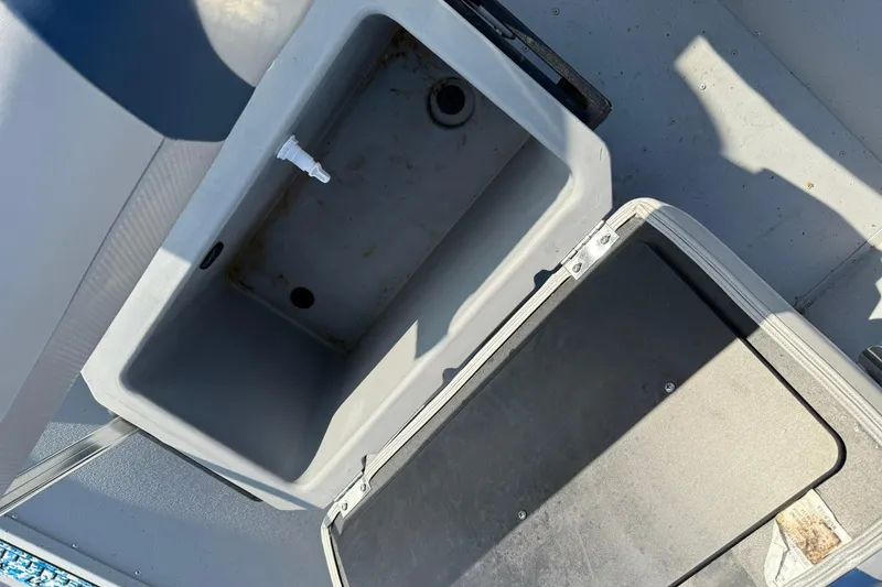 Slide: The Image of 2022 G3 Gator Tough 17 CCJ DLX boat storage compartment, open and empty. - 12