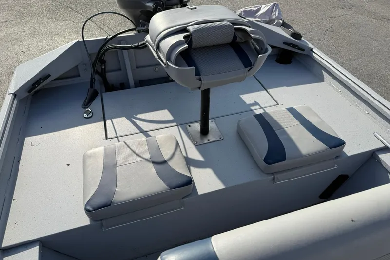 Slide: The Image of 2022 G3 Gator Tough 17 CCJ DLX boat interior with seating and controls. - 17