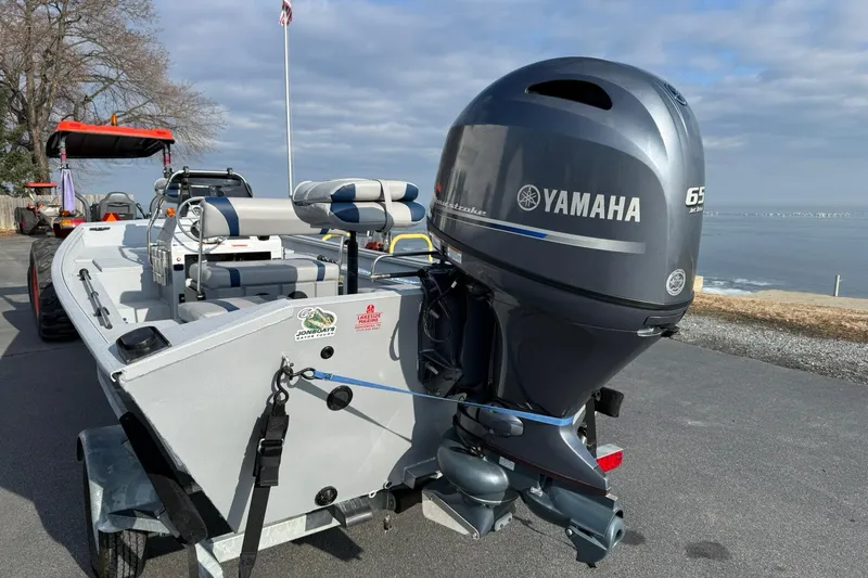 Slide: The Image of 2022 G3 Gator Tough 17 CCJ DLX boat with Yamaha engine, parked near waterfront. - 3