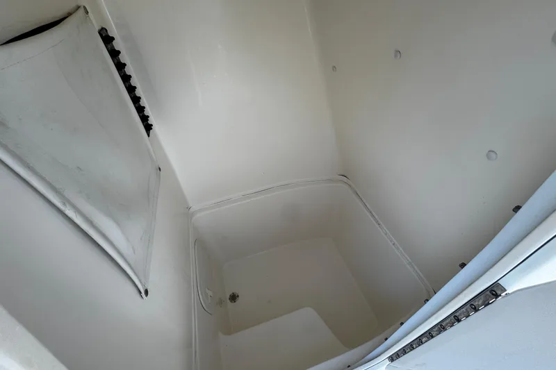 Slide: The Image of 2021 Cobia 220 Center Console storage compartment, spacious and clean interior. - 13