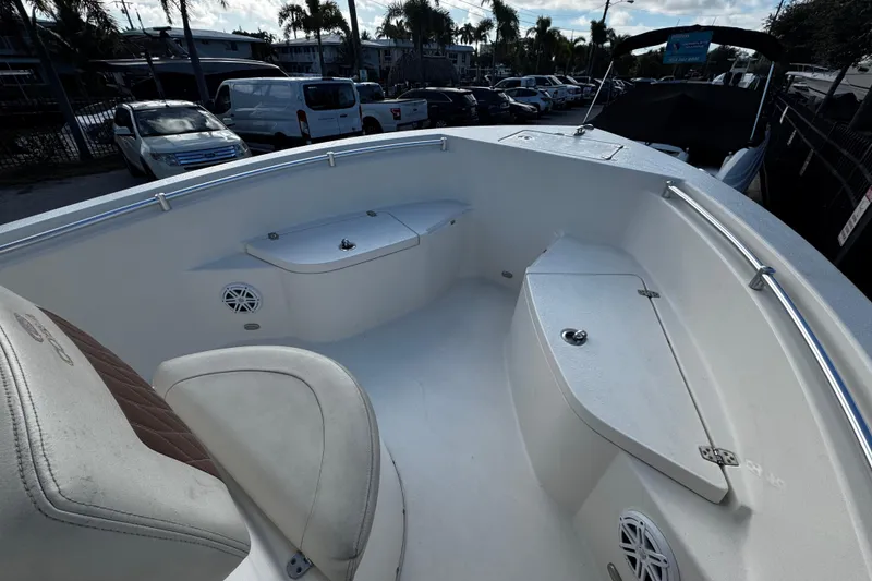 Slide: The Image of 2021 Cobia 220 Center Console boat interior with seating and storage compartments. - 14