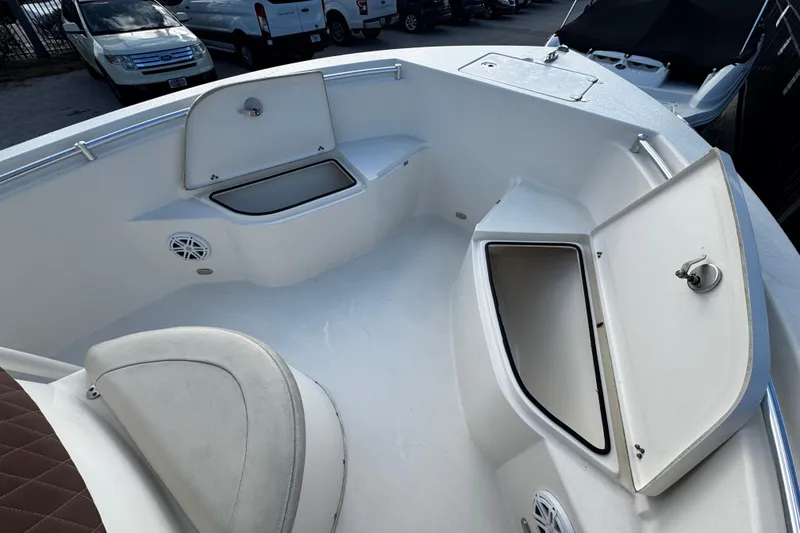 Slide: The Image of 2021 Cobia 220 Center Console boat interior with open storage compartments. - 15