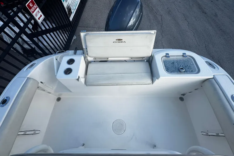 Slide: The Image of 2021 Cobia 220 Center Console boat interior with seating and storage compartments. - 2