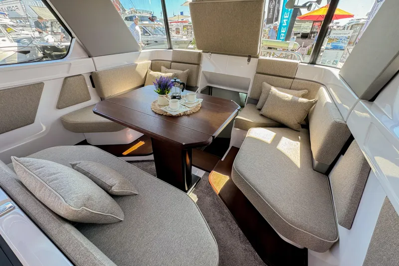 Slide: The Image of Luxurious interior of 2024 Axopar 45 XC Cross Cabin with plush seating and elegant table. - 11