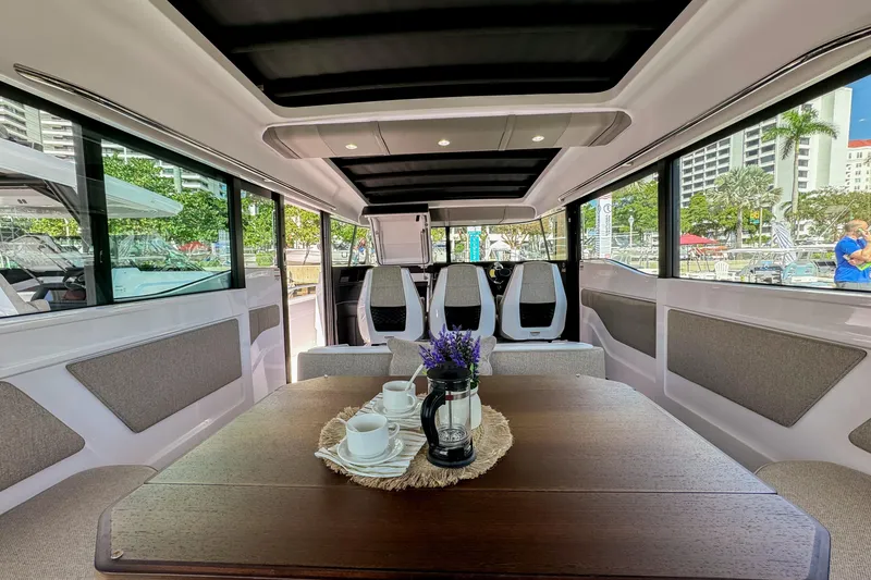Slide: The Image of Interior of 2024 Axopar 45 XC Cross Cabin with elegant seating and table setup. - 16